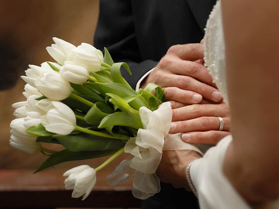 hands of bride and groom with tulips